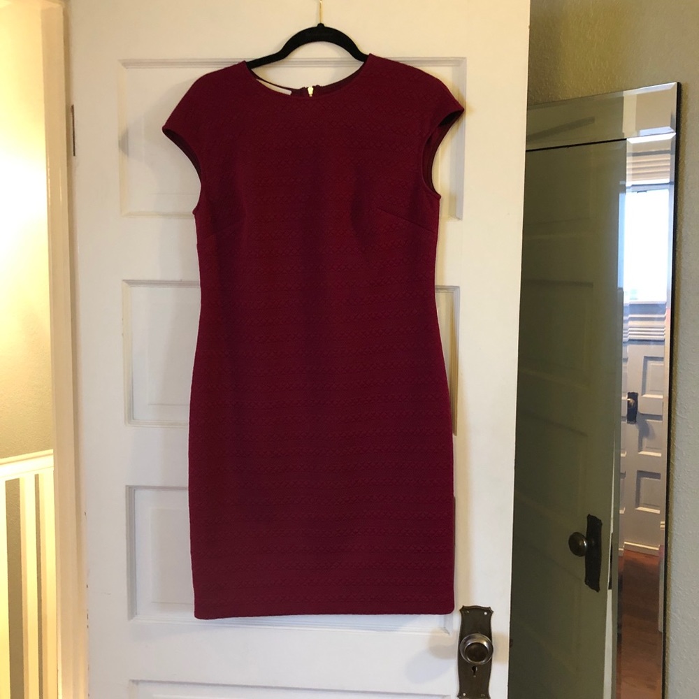 Dark pink, knee length dress.